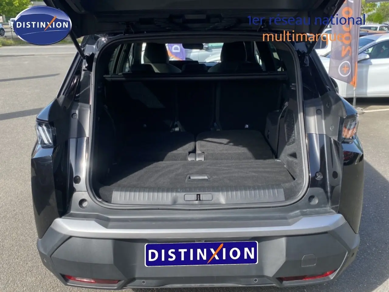 Vue arrière du Peugeot 5008 noir Perla Nera avec coffre ouvert montrant un espace de chargement spacieux et modulable.
