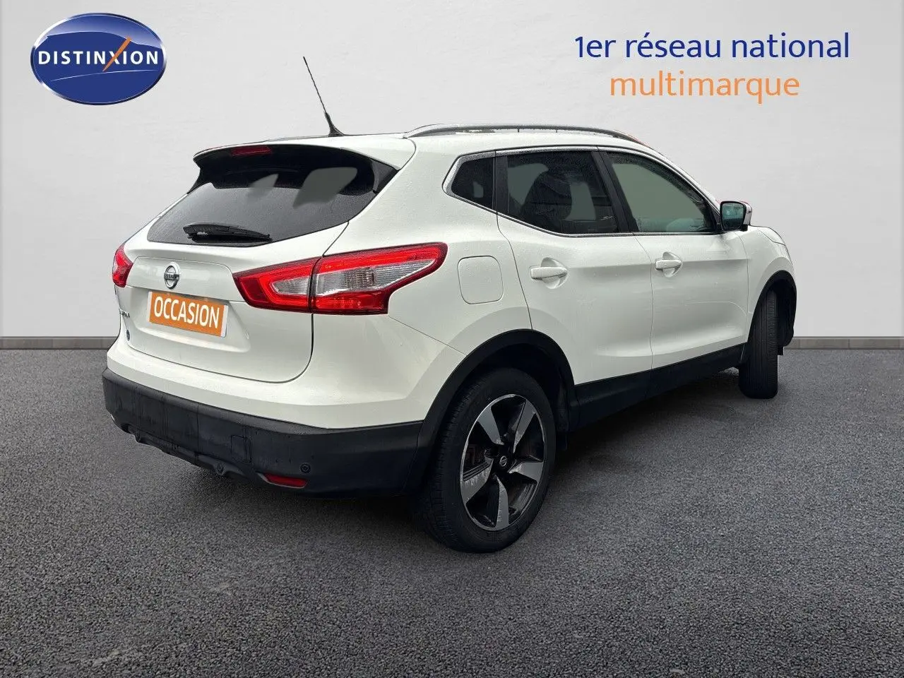 Vue 3/4 arrière droite d'un Nissan Qashqai blanc glacier avec jantes biton et vitres teintées.