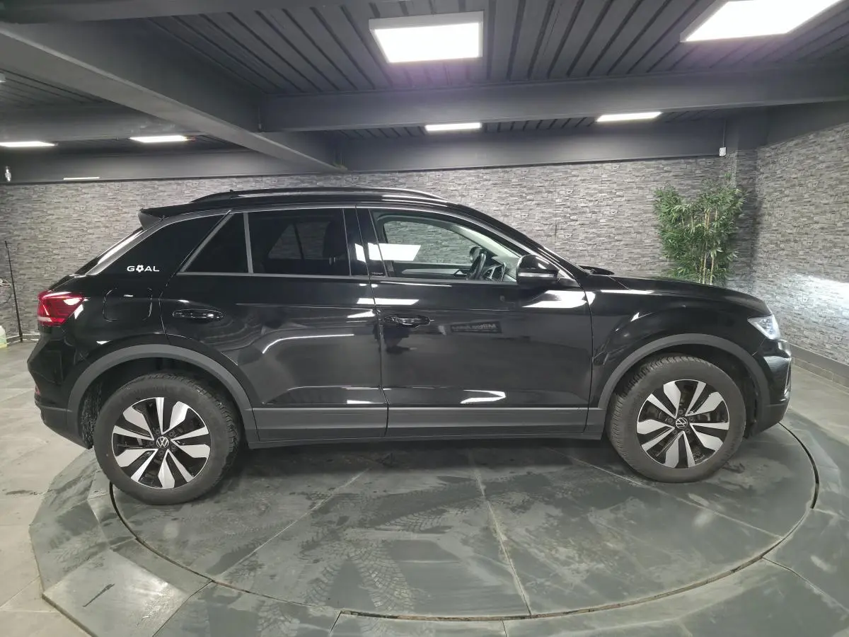 Profil droit du Volkswagen T-Roc noir intense 2025 avec jantes alliage 17 pouces et logo Goal sur l'aile arrière.