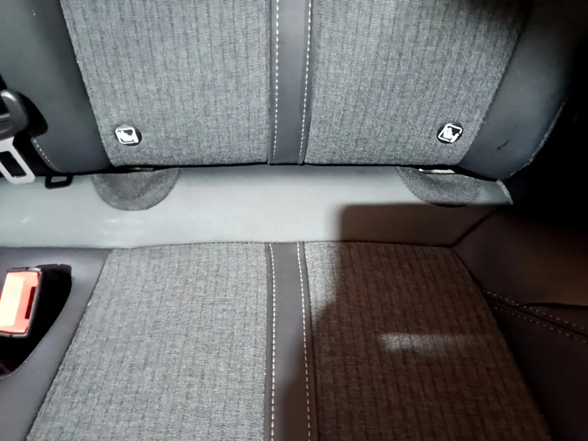 Gros plan sur la banquette arrière gris foncé du Peugeot 3008 GT Line avec fixation Isofix visible.