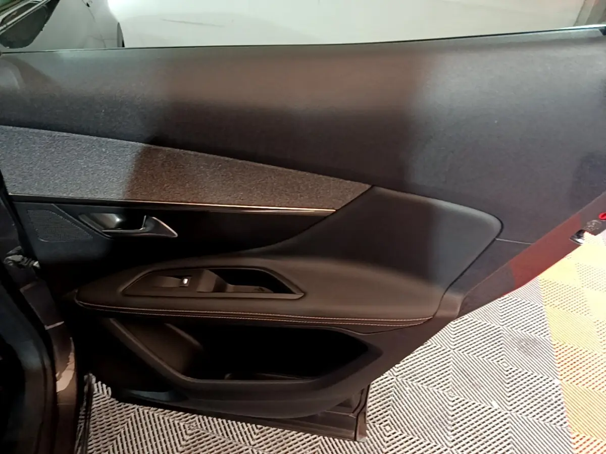 Vue intérieure du panneau de porte côté gauche du Peugeot 3008 GT Line 2020, finition cuir noir avec surpiqûres contrastantes.