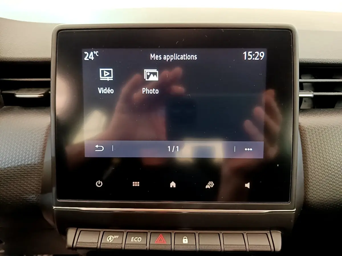 Écran tactile central affichant les applications vidéo et photo dans l’habitacle d’une Renault Clio Business Blue dCi 85 blanche.