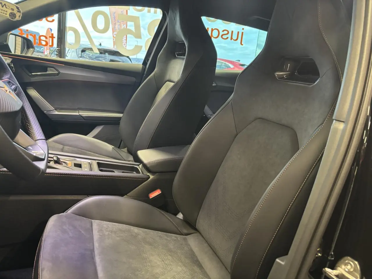 Intérieur côté droit de la CUPRA Leon 2.0 TDI 2026 avec sièges baquets suédine noire et surpiqûres cuivrées.