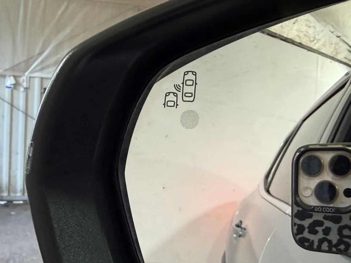 Rétroviseur extérieur gauche du Citroën C5 Aircross gris clair avec icône d’alerte angle mort visible.