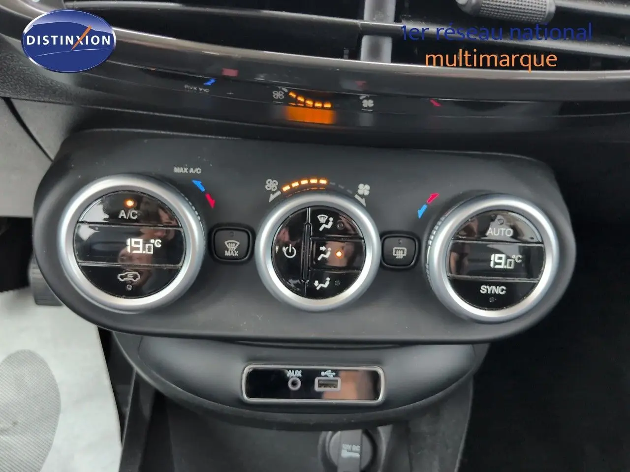 Gros plan sur la console centrale de la Fiat 500X 2018, montrant les commandes de climatisation bi-zone et prises audio.