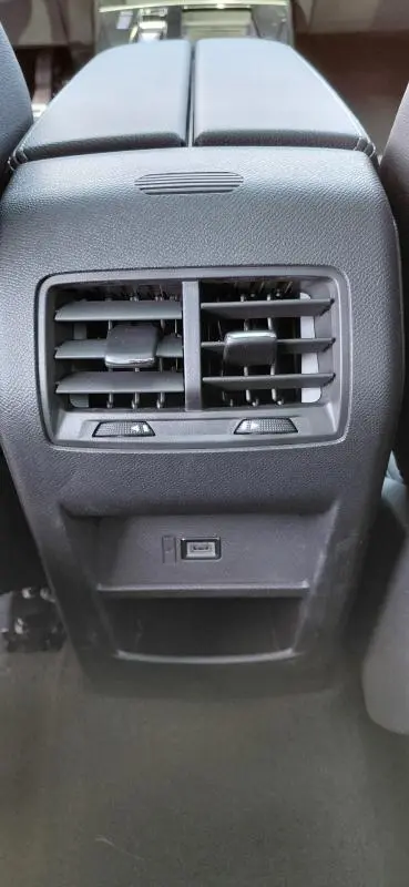 Gros plan sur la console arrière noire de l’Opel Astra 2025, avec bouches d’aération et port USB visibles.