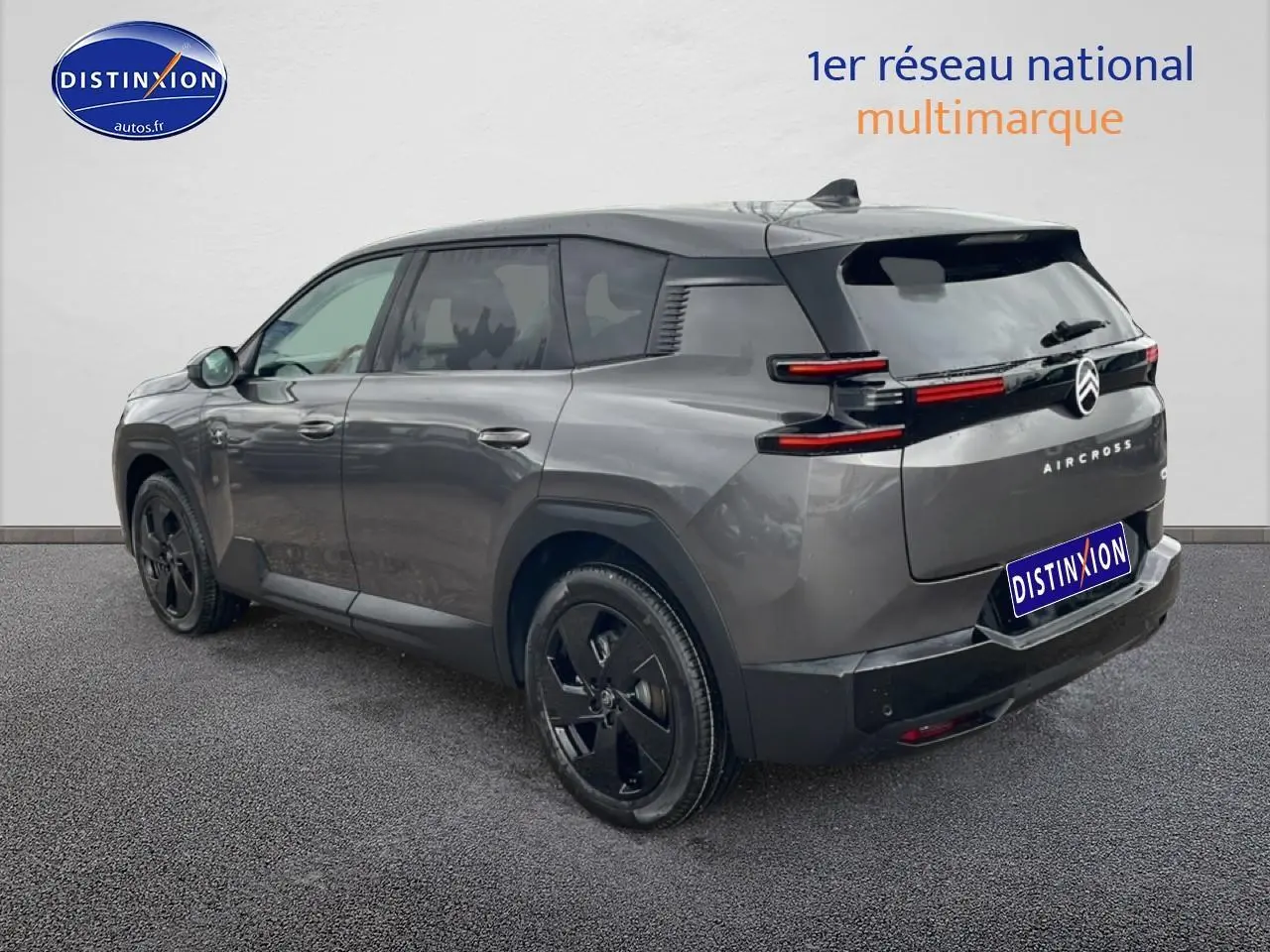 Vue 3/4 arrière droite d'un Citroën C5 Aircross gris platinium avec jantes noires et feux arrière LED distinctifs.