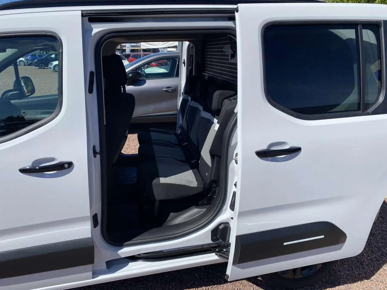 Vue côté droit du Citroën Berlingo blanc 2025 avec porte latérale coulissante ouverte dévoilant les sièges arrière.