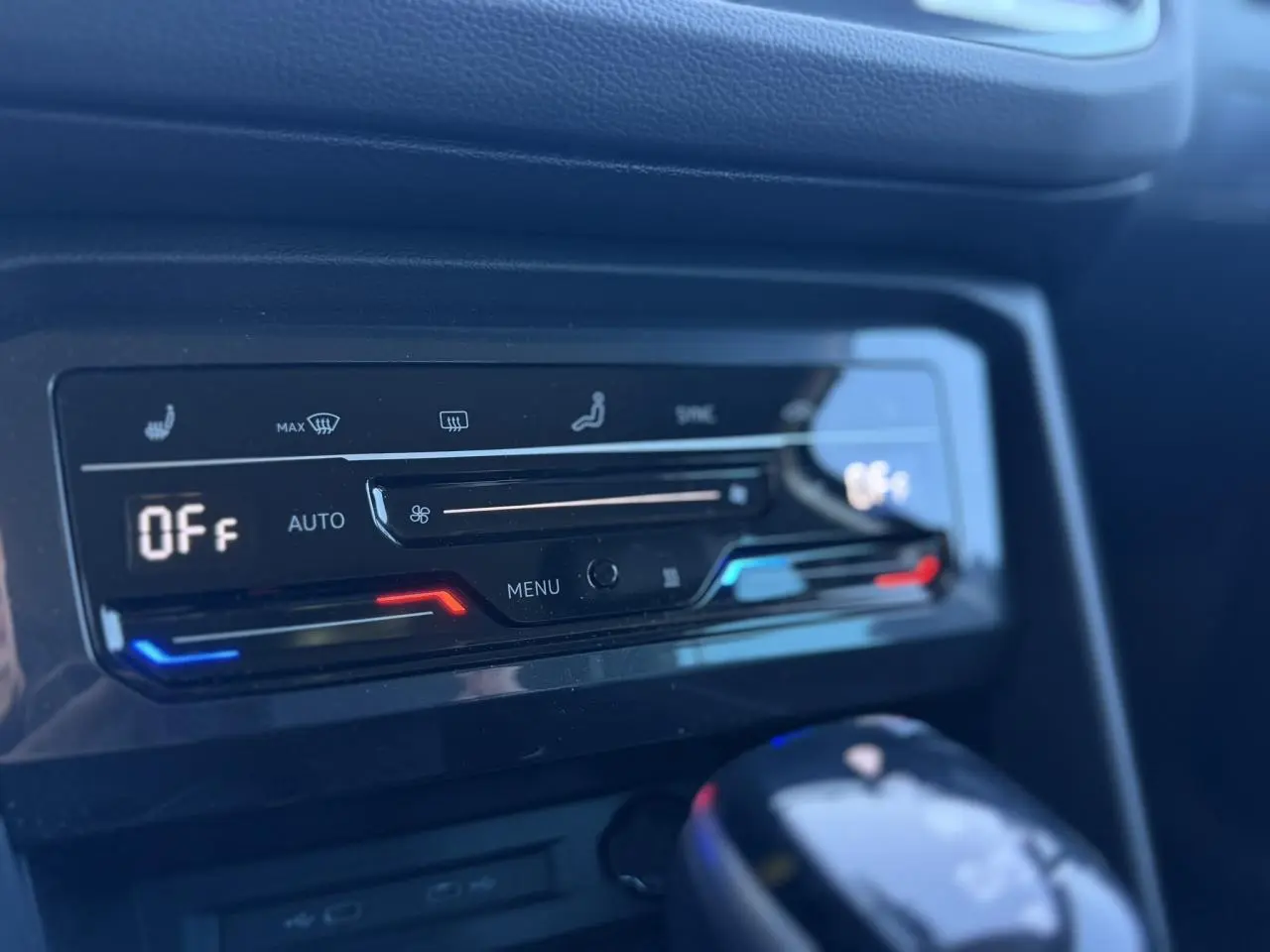 Détail de la console centrale du Volkswagen Tiguan 2024 avec commandes climatisation automatique et levier de vitesse noir brillant.
