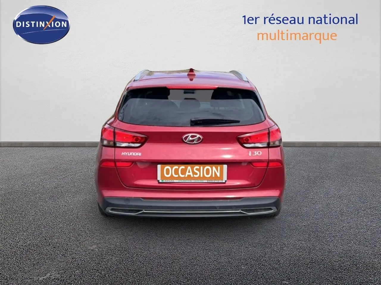 Vue arrière d'une Hyundai i30 SW 2023 en rouge Sunset Red Metal avec plaque "OCCASION" visible.
