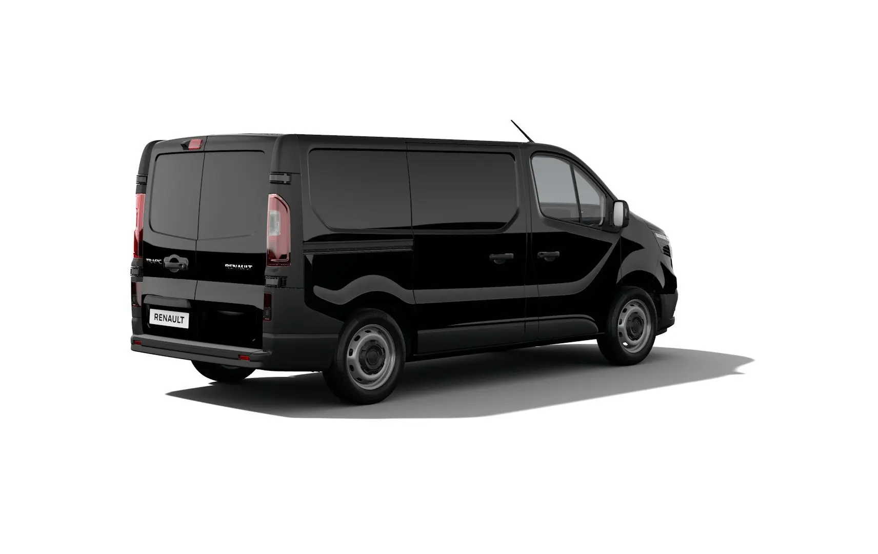 Profil droit du Renault Trafic Fourgon noir crépuscule, version Van L1H1 BluedCi 150 Advance 3T, stationné devant un bâtiment.