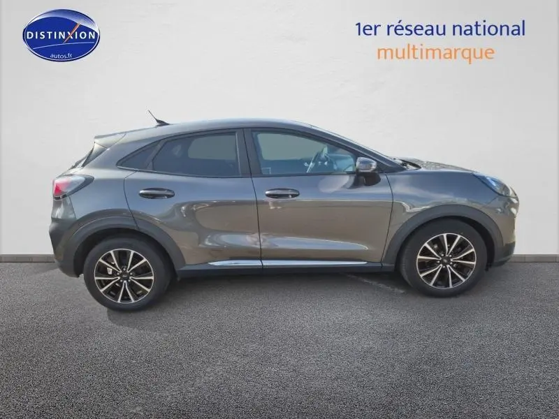 Vue latérale droite d'une Ford Puma 2022 gris métallisé avec jantes alliage et lignes fluides distinctives.