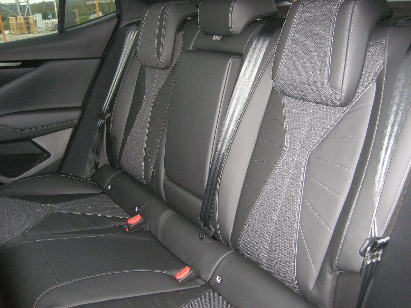 Vue rapprochée des sièges arrière en cuir noir et tissu gris du DS4 II Pallas 2024, soulignant leur design élégant.