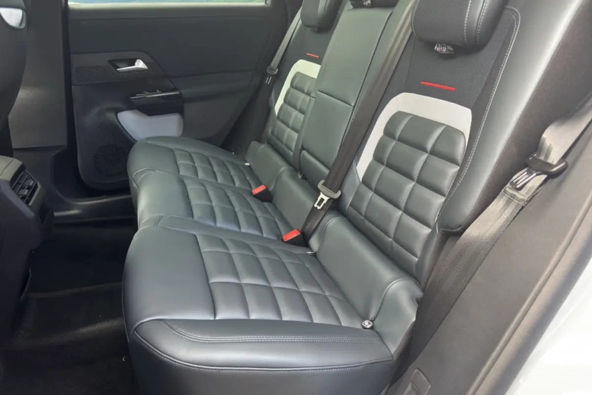 Vue latérale de la banquette arrière cuir noir matelassé avec ceintures et détails gris du Citroën C5 Aircross 2026.