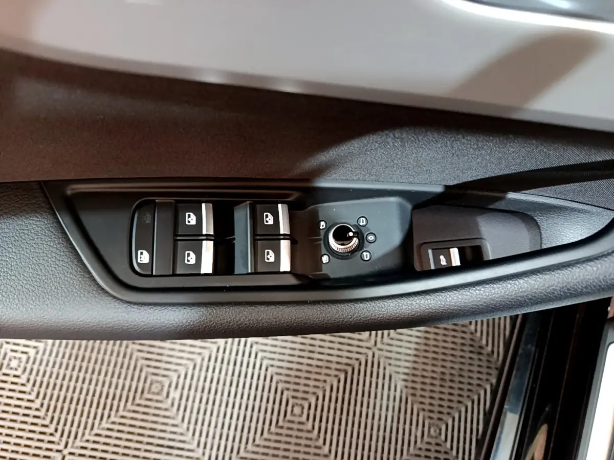 Commande des vitres et réglage des rétroviseurs côté gauche sur la portière noire d'une Audi A5 2021.