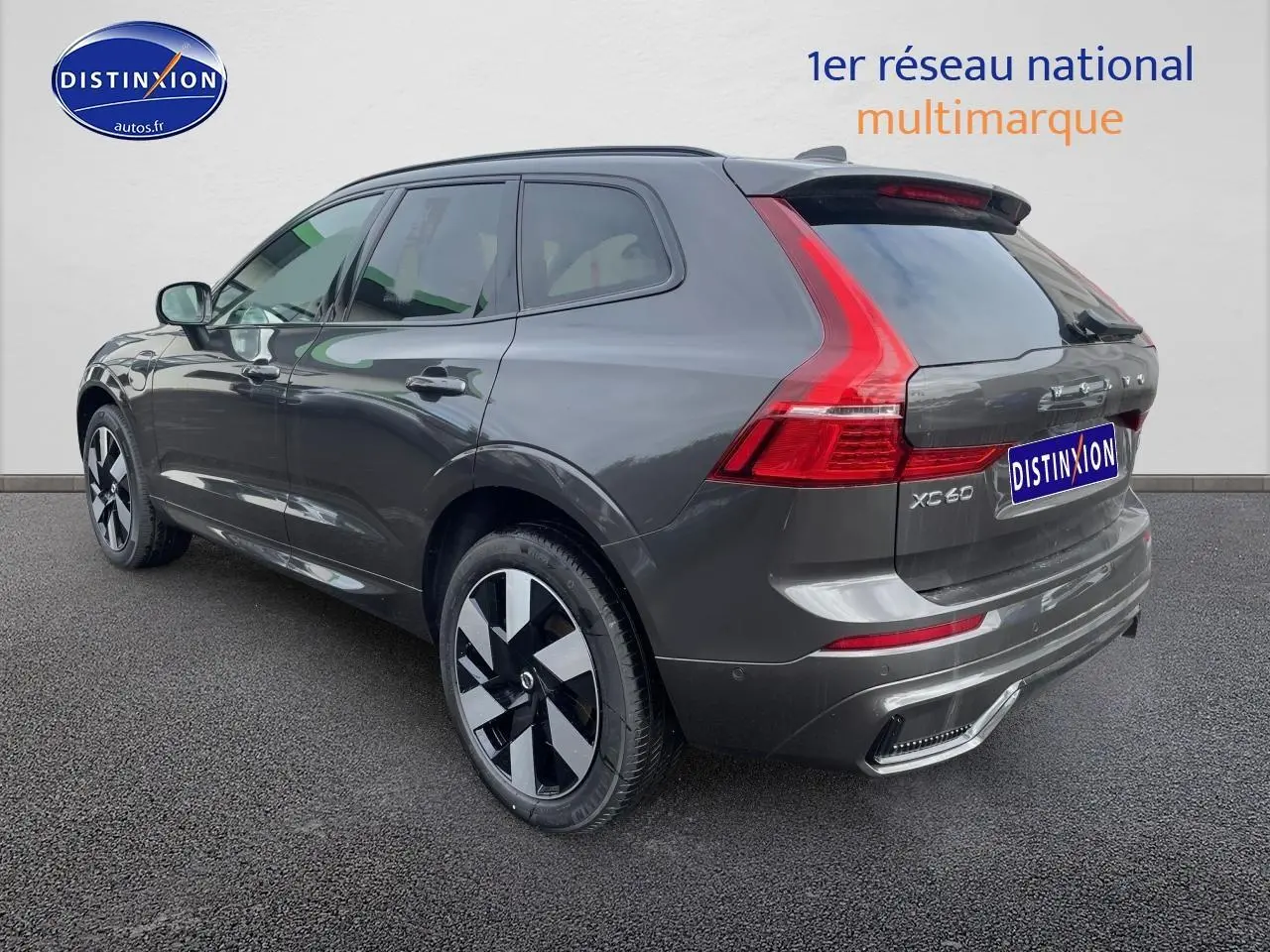 Vue 3/4 arrière droite d’un Volvo XC60 gris métallisé avec feux arrière LED et jantes alliage distinctives.