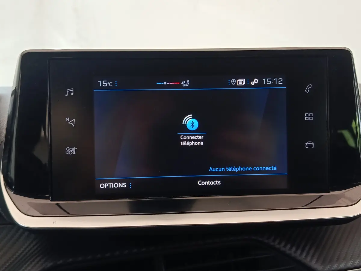 Écran tactile central de 7 pouces de la Peugeot 208 blanc, affichant la connexion Bluetooth téléphone.