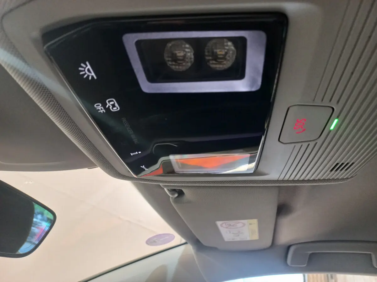 Vue rapprochée du plafonnier intérieur avec commandes lumineuses et bouton SOS de la Volkswagen Golf bleue 2022