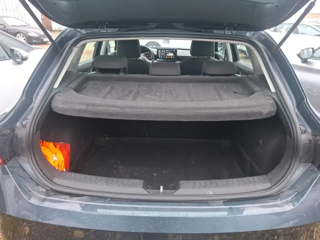 Coffre ouvert vu de l'arrière d'une SEAT LEON gris 2021, avec cache-bagages et intérieur noir visible.