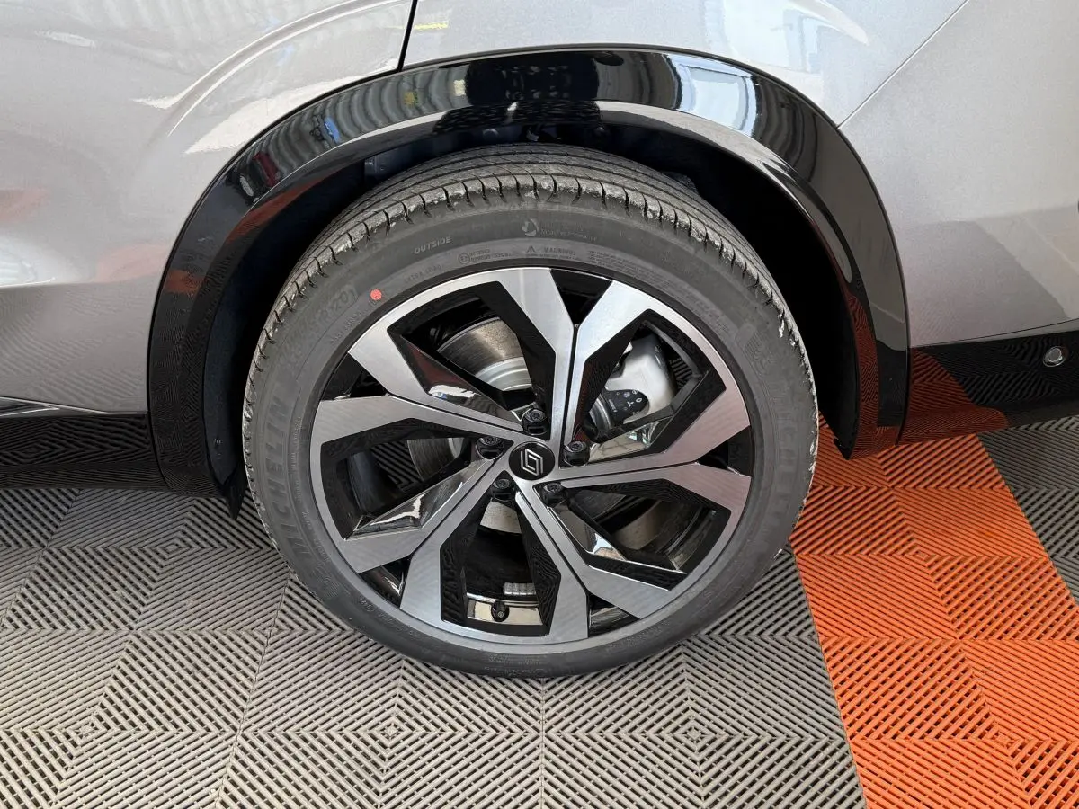 Gros plan sur la roue arrière droite gris foncé du Renault Espace esprit Alpine 7PL avec jante alliage noire et argentée.