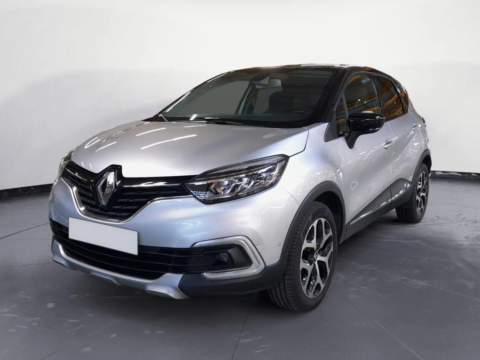 Renault Captur TCe 120 Energy Iridium 2017 gris clair métal avec toit noir, vue 3/4 avant droit, jantes alliage distinctives.