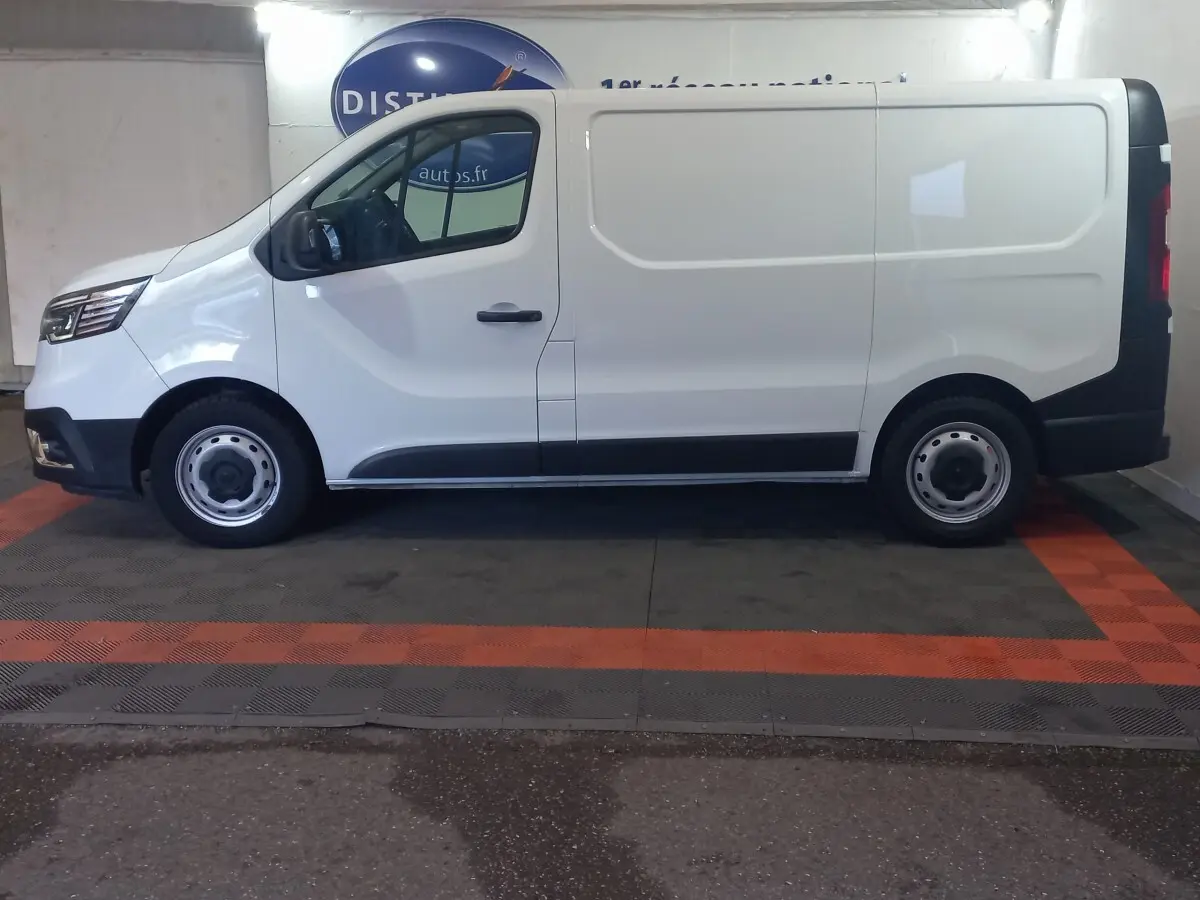 Profil droit du Renault Trafic Fourgon blanc 2022, avec porte latérale coulissante et jantes acier noires.