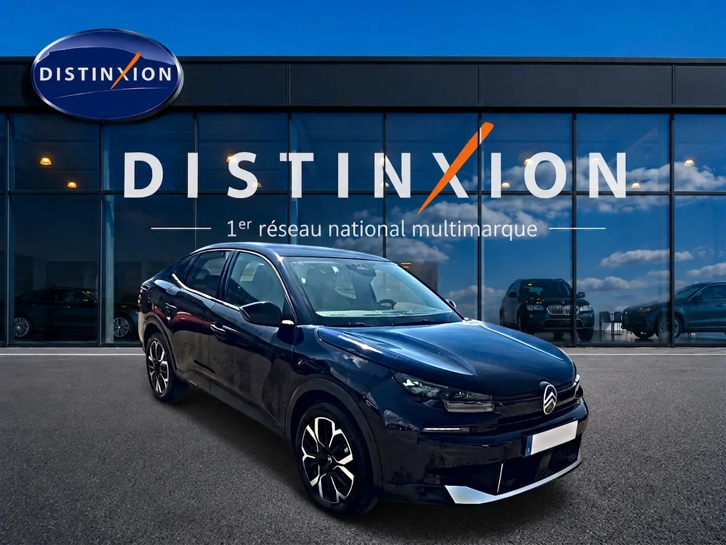 Citroën C4 X bleu vue 3/4 avant droit, avec calandre distinctive et jantes alu noires et argentées.