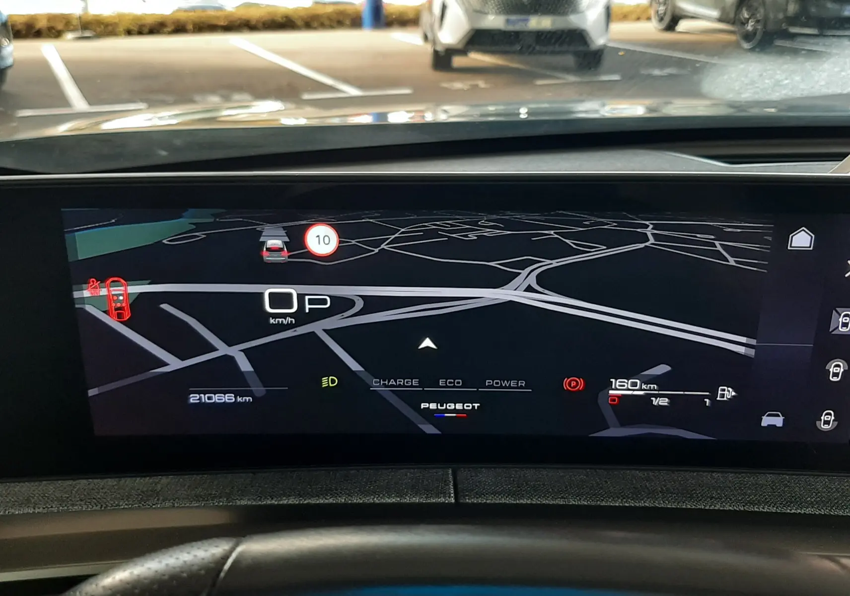 Vue intérieure du tableau de bord numérique du Peugeot 3008 Hybrid 145ch GT, affichant la navigation et les informations de conduite.
