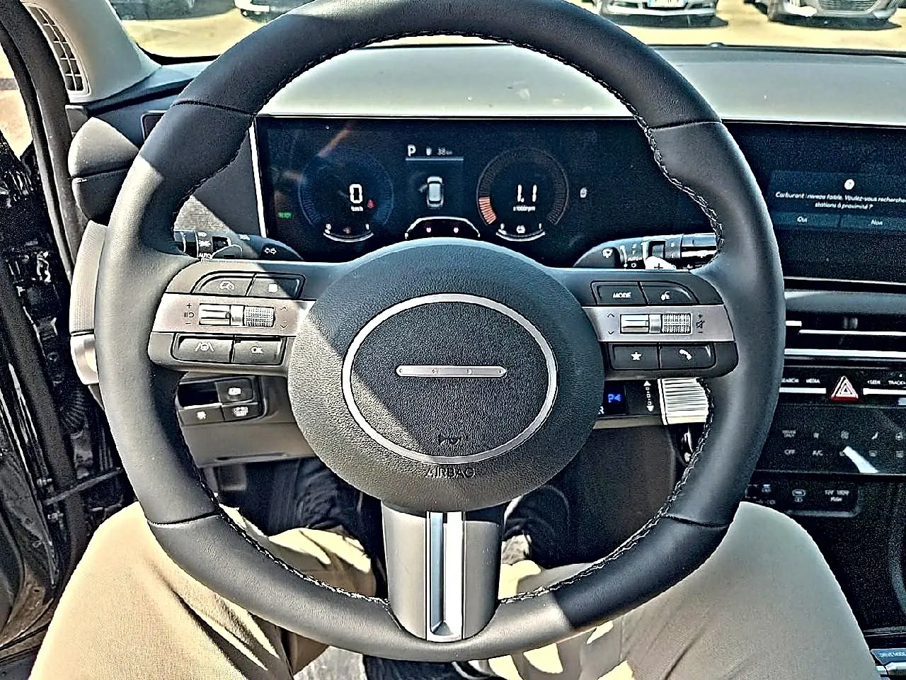 Vue intérieure centrée sur le volant cuir multifonction noir du Hyundai Tucson 2026 avec tableau de bord numérique.