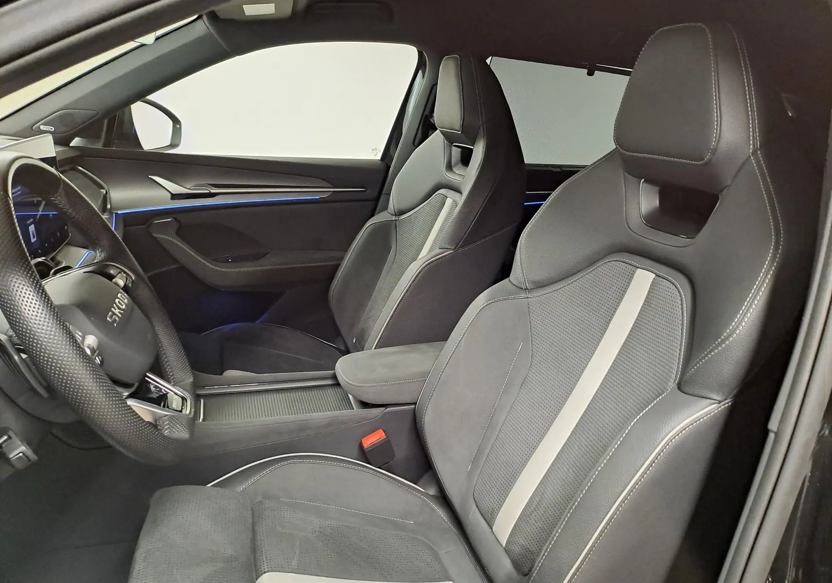 Vue intérieure côté gauche du Skoda Kodiaq 2025 noir Magic nacré, sièges sport en cuir et alcantara avec surpiqûres contrastées.