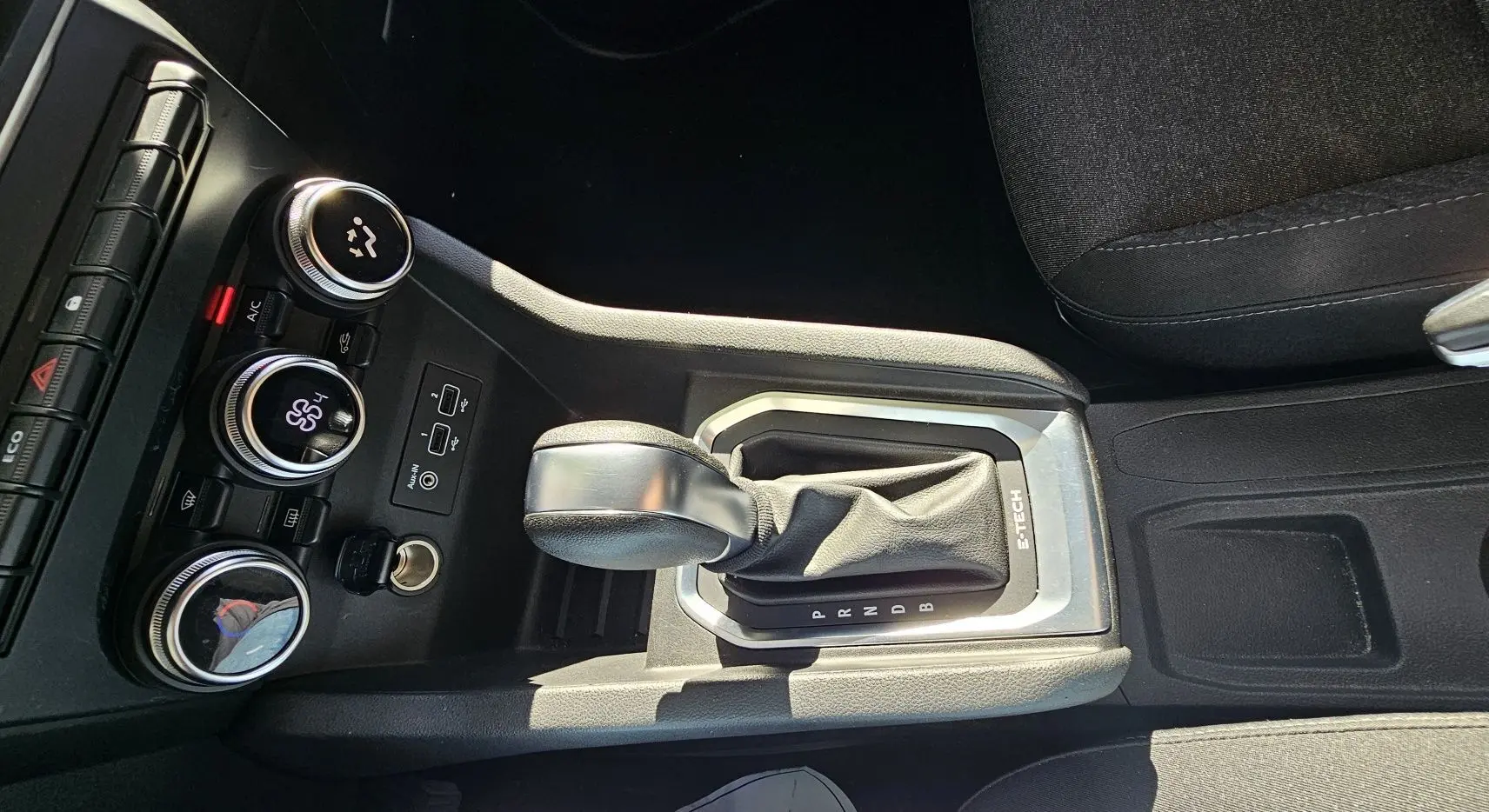 Le levier de vitesses automatique E-TECH de la Renault Clio blanche, avec commandes de climatisation et ports USB visibles.