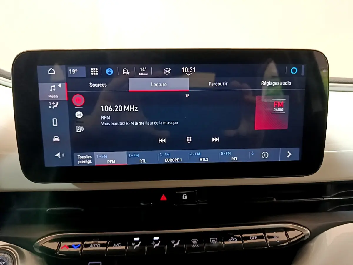 Écran tactile central affichant la radio FM dans l'habitacle blanc de la FIAT 500 42kWh Icône 2022