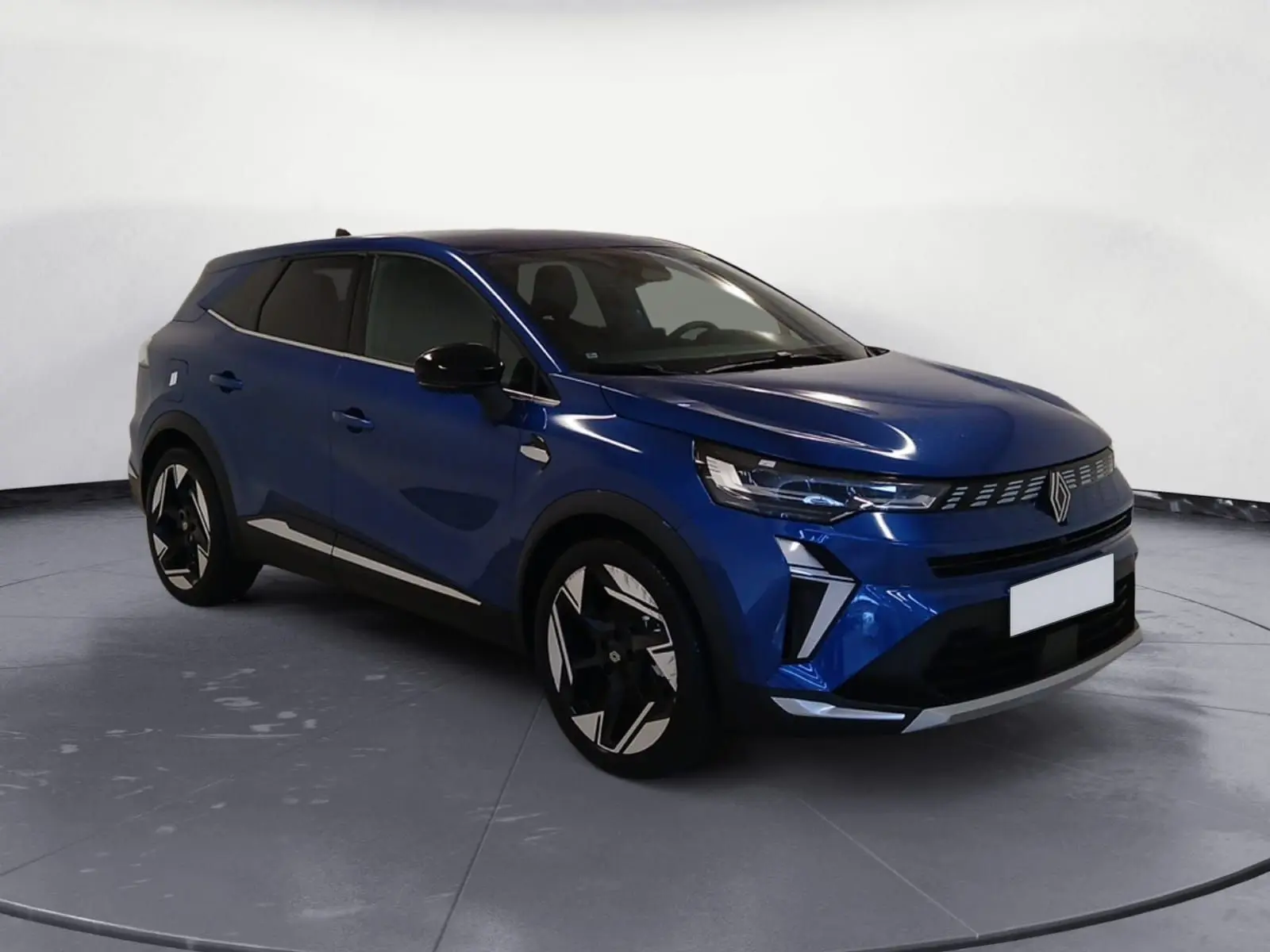 Renault Symbioz E-Tech Full Hybrid 145 Iconic bleu iron en 3/4 avant droit, avec calandre lumineuse et jantes modernes.