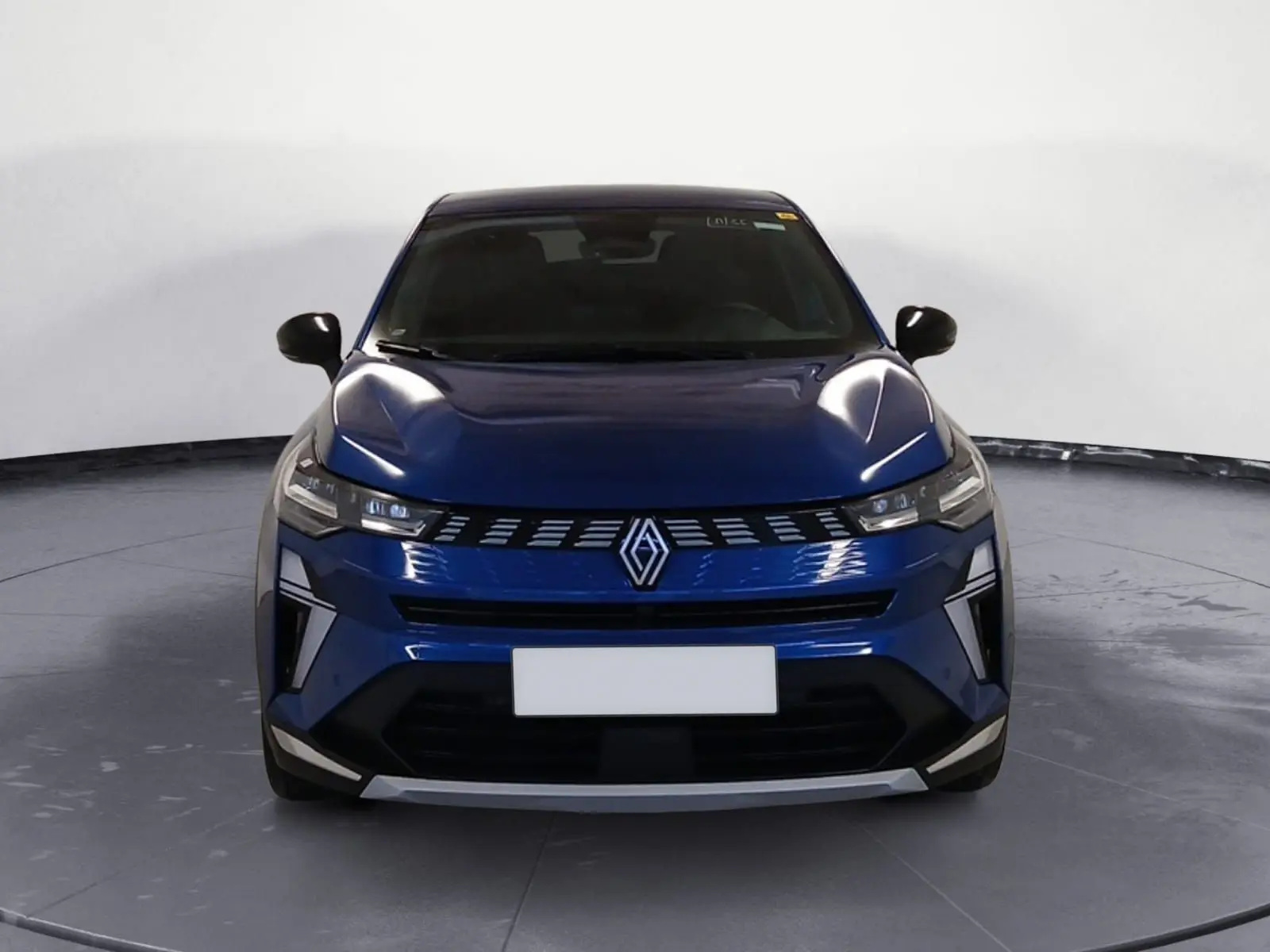 Vue de face du Renault Symbioz E-Tech Full Hybrid 145 Iconic 2025 en bleu Iron avec calandre distinctive et phares LED fins.