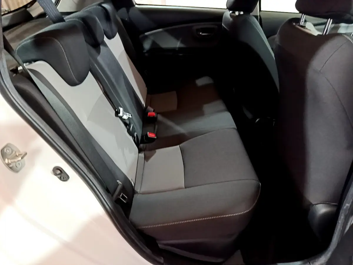 Vue côté gauche sur la banquette arrière bicolore noire et grise de la Toyota Yaris 1.5 Hybride 2020 blanche