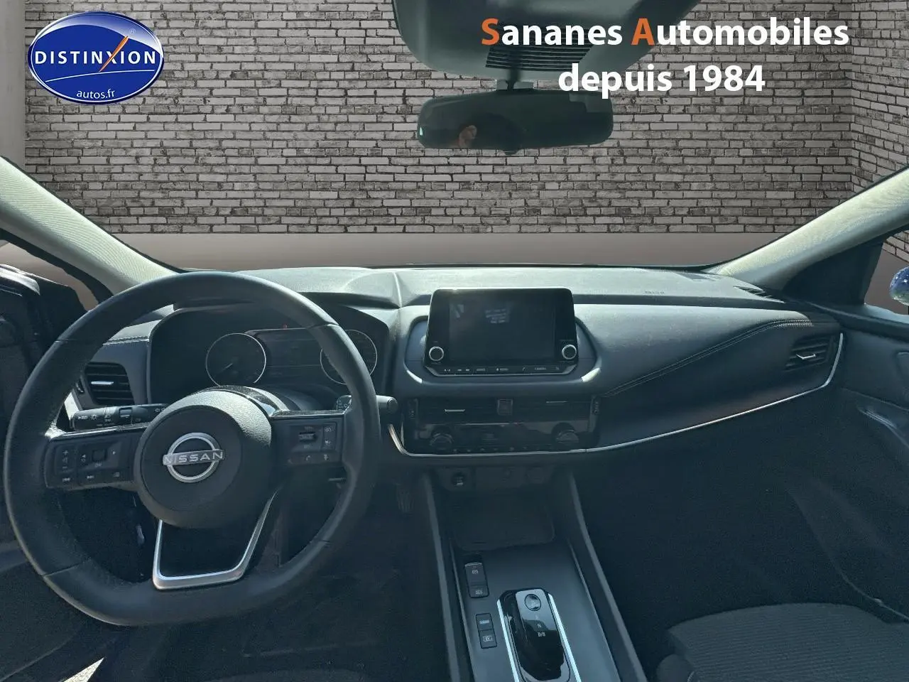 Vue intérieure du tableau de bord et volant du Nissan Qashqai 1.5 e-Power 2023 avec écran tactile central et commandes au volant.