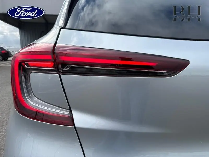 Gros plan sur le feu arrière gauche rouge du Renault Captur gris Highland, soulignant la ligne moderne du hayon.