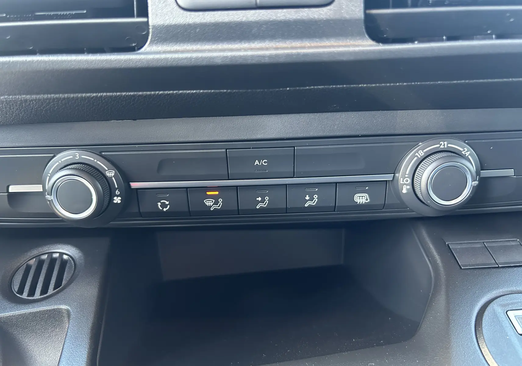 Vue rapprochée du tableau de bord du Peugeot Partner Fourgon 2026, montrant les commandes de climatisation et ventilation.