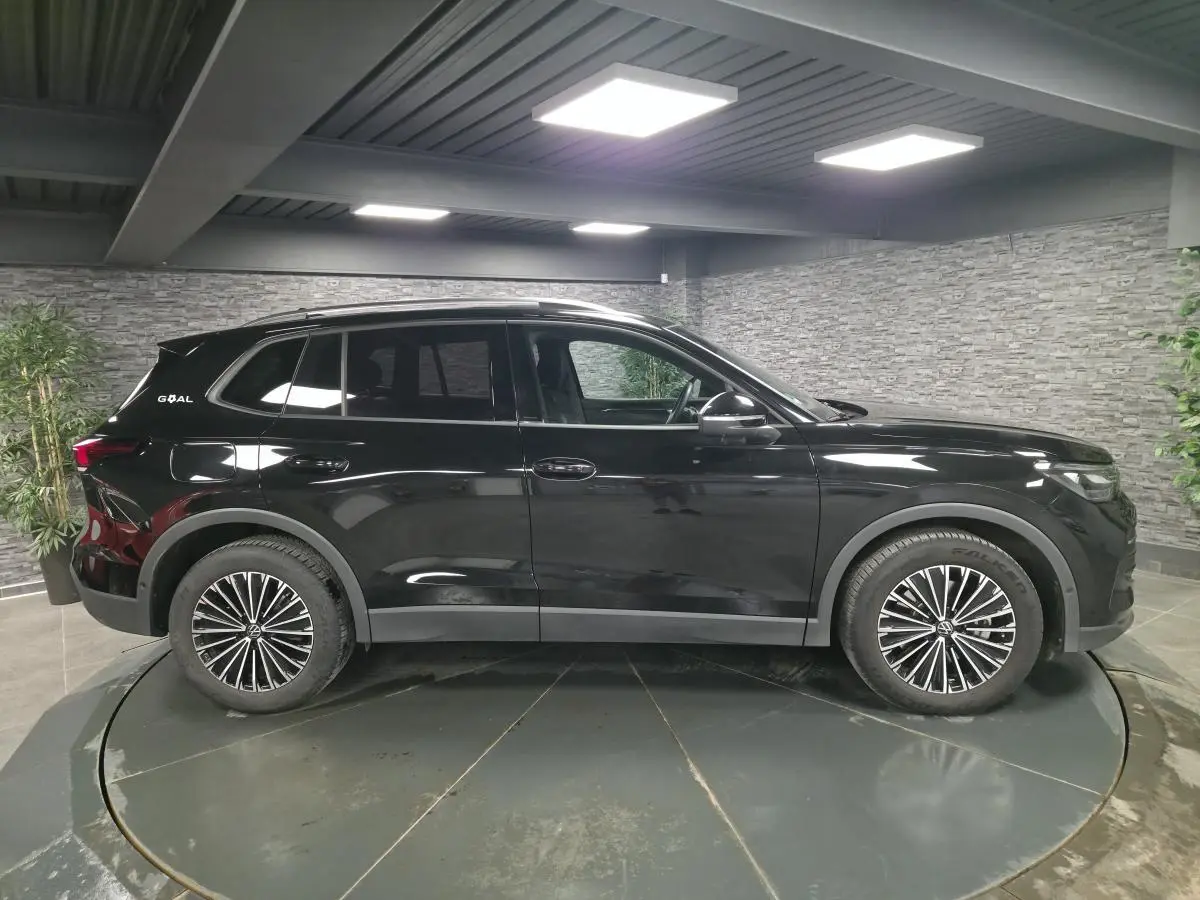 Vue de profil côté gauche d'un Volkswagen Tiguan noir 2025 avec jantes alliage et badge GOAL à l'arrière.