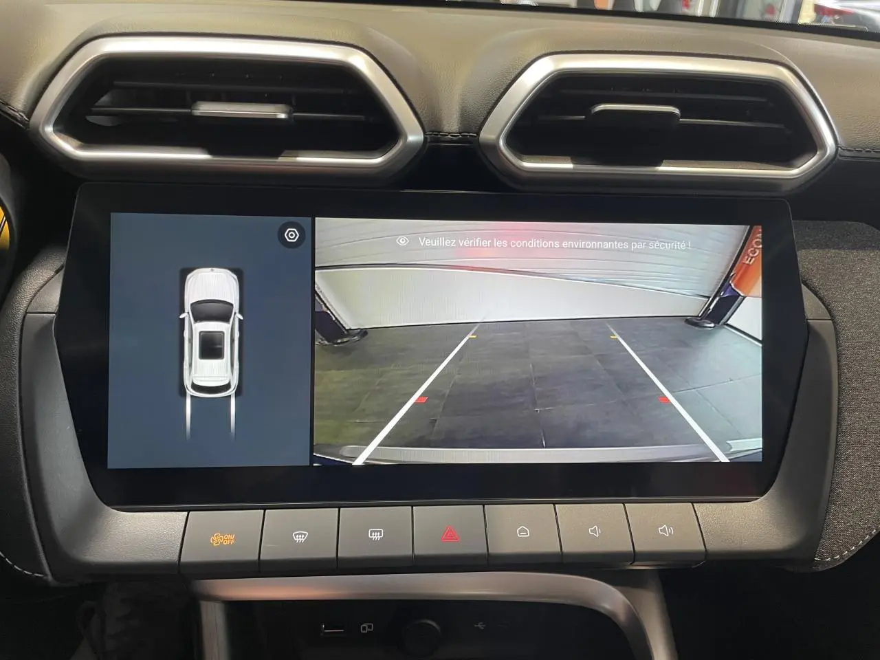 Écran tactile central affichant la caméra de recul et l’aide au stationnement dans un MG Motor ZS gris clair.