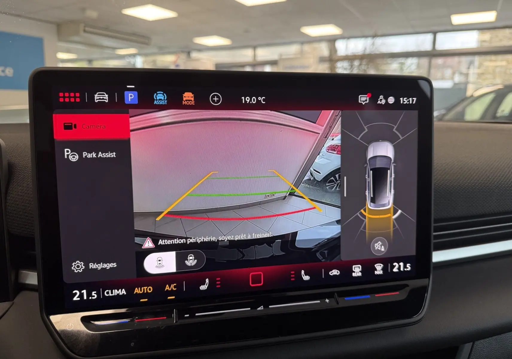 Écran tactile intérieur du Volkswagen T-Roc noir, affichant la caméra de recul et l'assistance au stationnement.