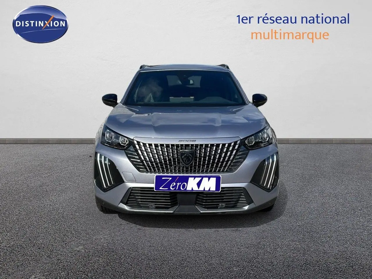 Peugeot 2008 gris Artense métal vue de face avec calandre distinctive et feux LED verticaux allumés.