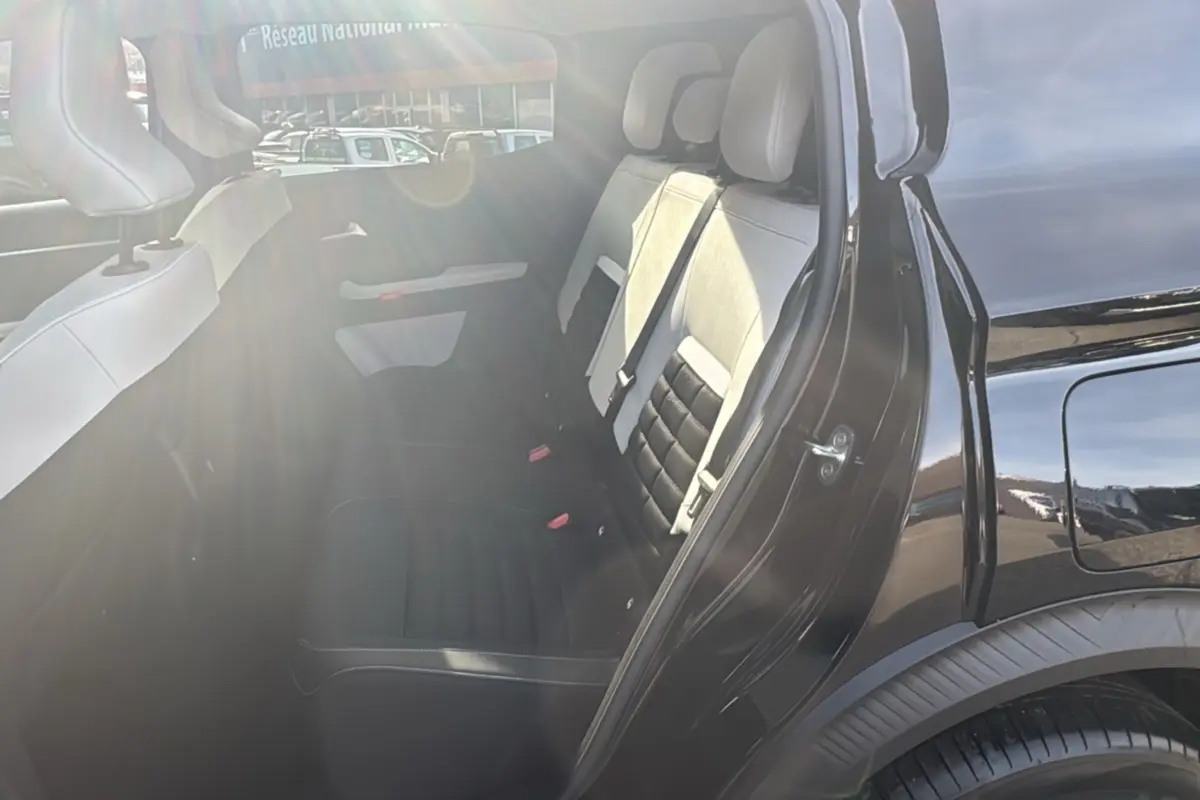 Vue côté gauche arrière d'une Citroën C3 Aircross noir perla nera avec banquette arrière bicolore et vitres surteintées.