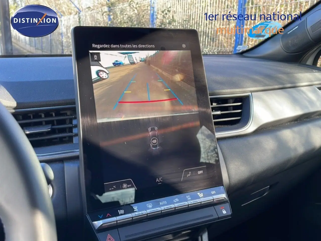 Vue intérieure centrée sur l'écran tactile affichant la caméra de recul du Renault Captur gris Rafale métal.