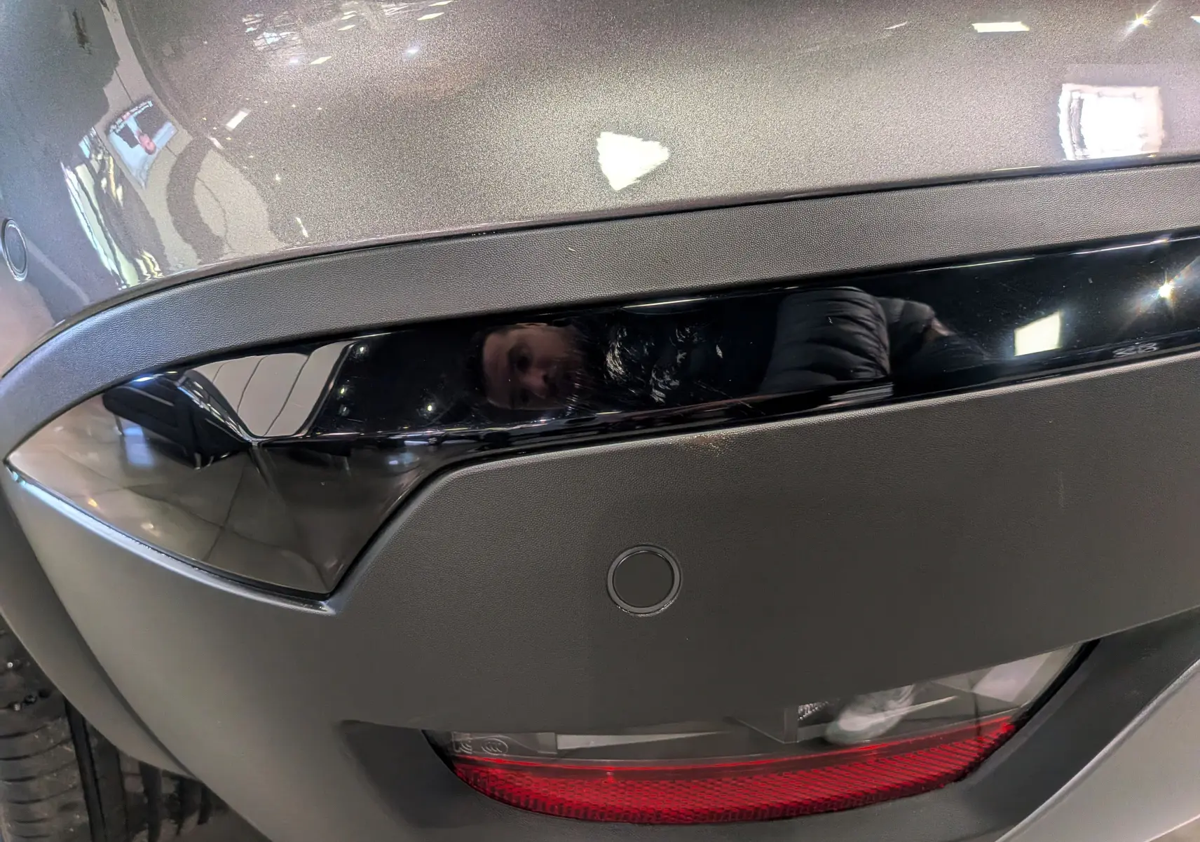 Gros plan sur le feu arrière droit gris Cassiopé du Renault Symbioz E-TECH Full Hybrid 2026 avec bande noire brillante.