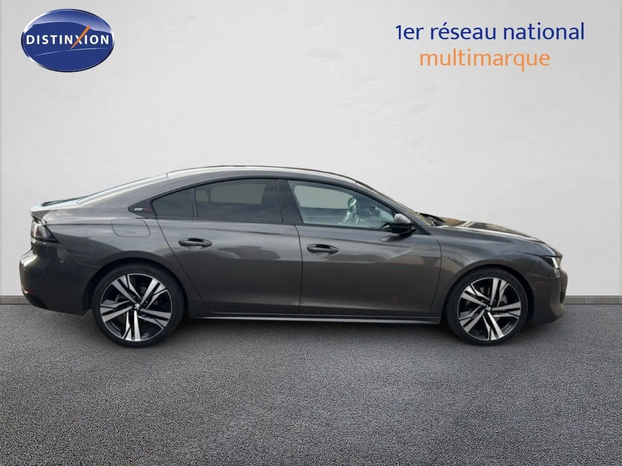Profil droit d'une Peugeot 508 gris platinium de 2020, finition GT Line avec jantes alliage bicolores et attelage visible.