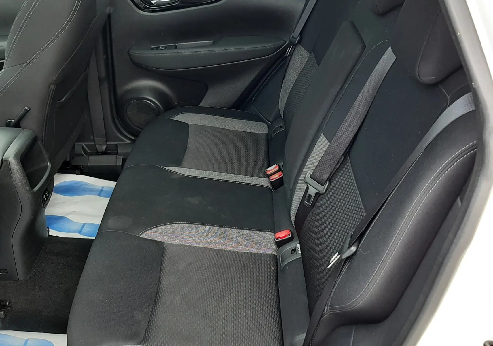 Vue intérieure côté droit des sièges arrière noirs en tissu du Nissan Qashqai blanc 2020.