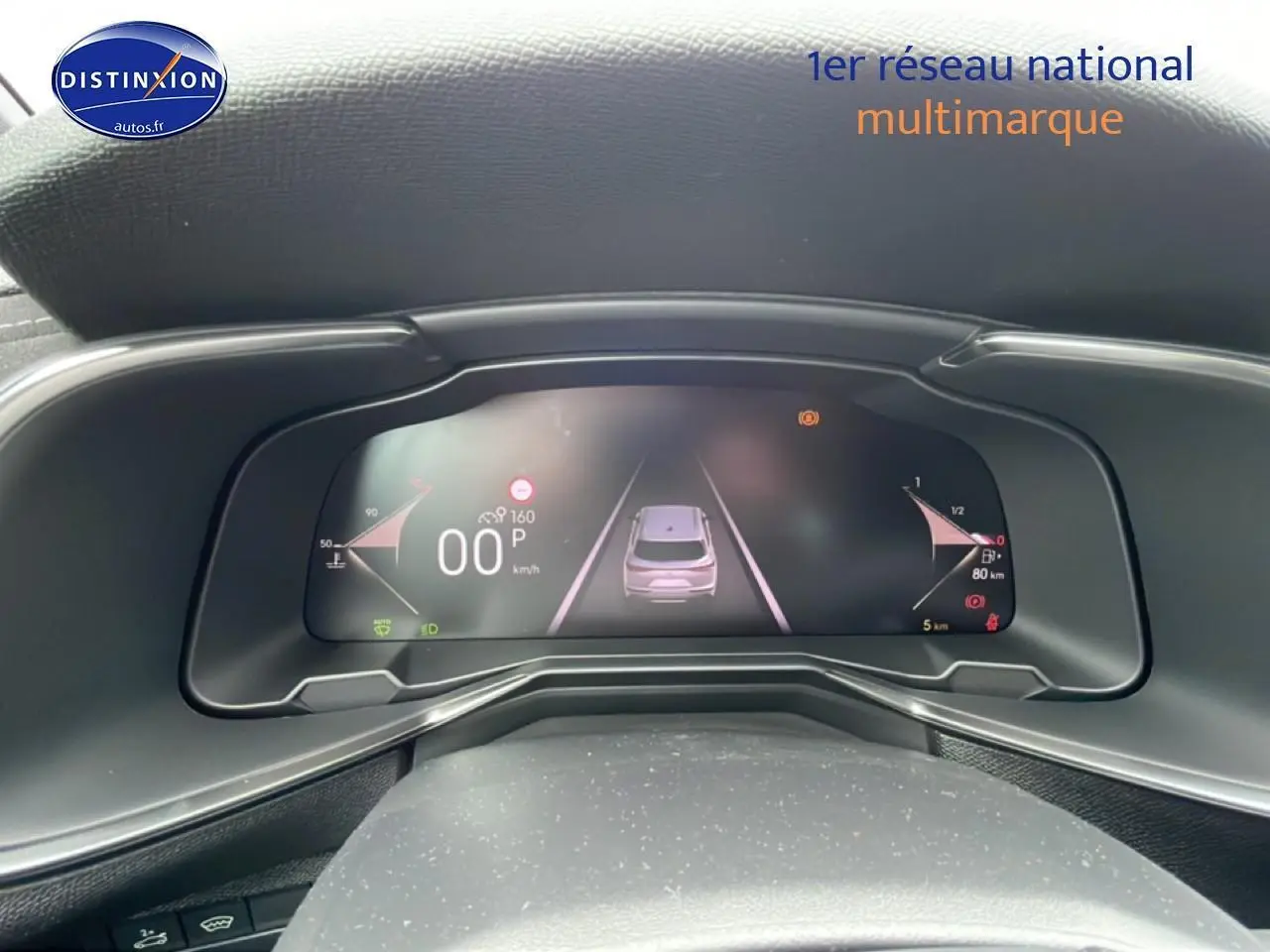 Vue rapprochée du tableau de bord numérique du DS7 1.5 BlueHDi 130 gris titane, affichant la vitesse et l'assistance au stationnement.