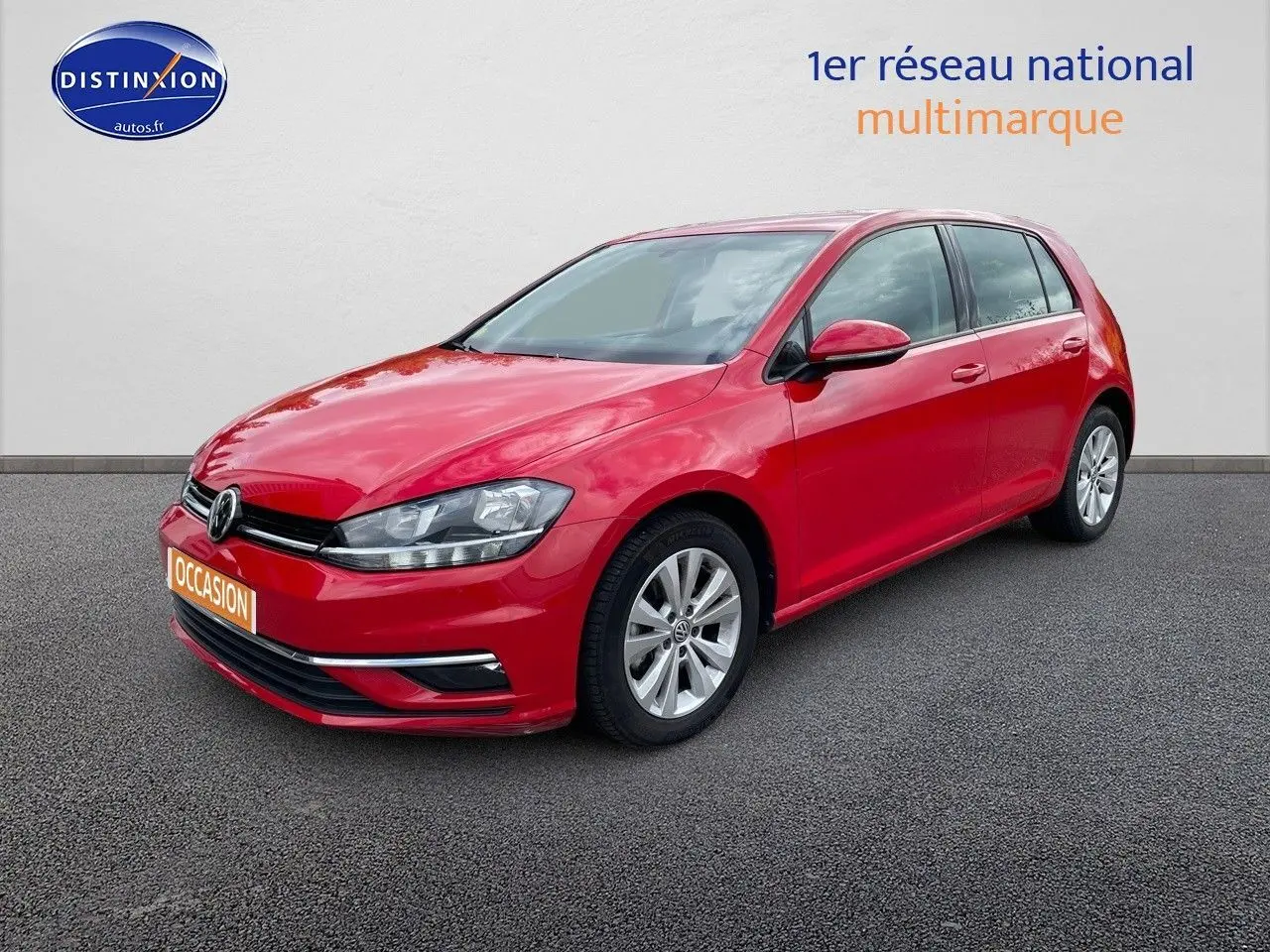 Volkswagen Golf VII rouge vue 3/4 avant droit, avec jantes alliage et calandre noire brillante.