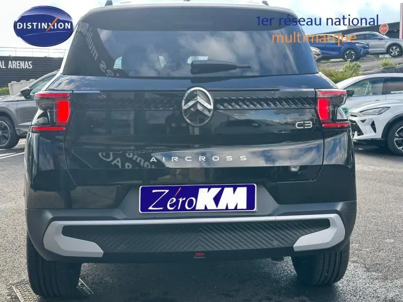 Vue arrière d'un Citroën C3 Aircross noir 2026 avec feux LED et logo chromé distinctif sur parking.